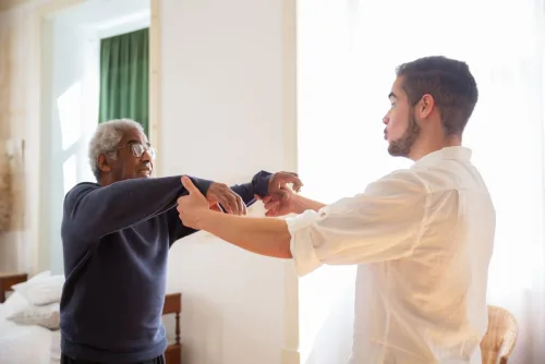 Caregiver sharing a warm moment with elderly patient at home